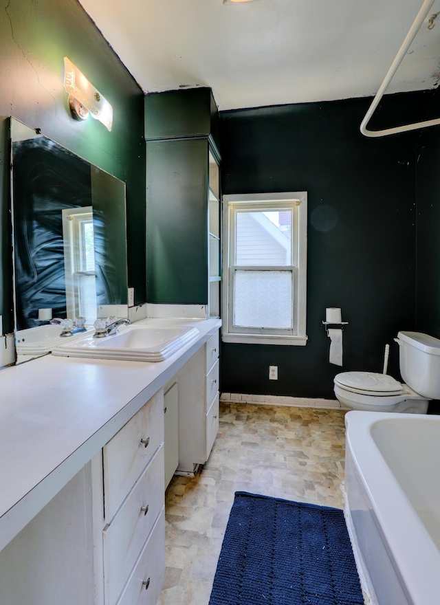 13 W 17th St, Holland, MI 49423 - full bathroom featuring toilet, a bathtub, vanity, and baseboards