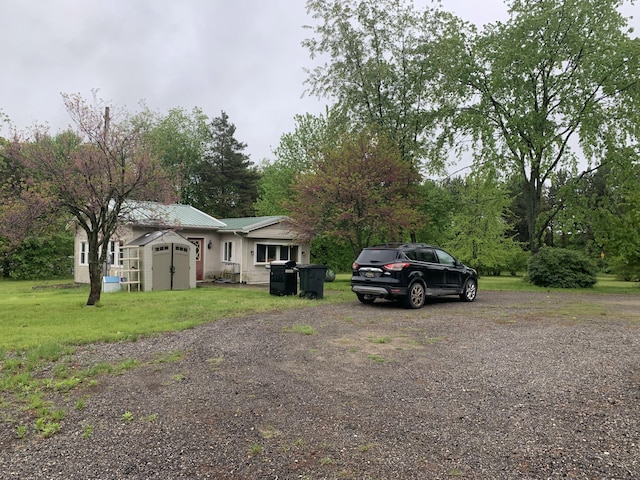 5501 Egner St NE, Cedar Springs, MI 49319 - view of front of home with metal roof and a front yard