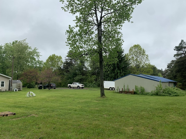 5501 Egner St NE, Cedar Springs, MI 49319 - view of grassy yard with view of wooded area