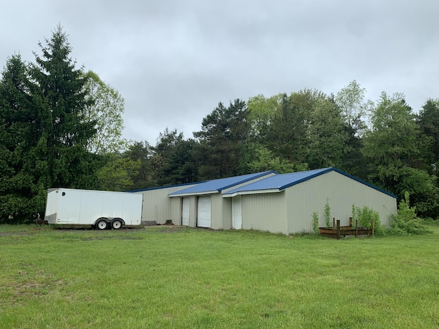 5501 Egner St NE, Cedar Springs, MI 49319 - view of grassy yard featuring a garage and an outdoor structure