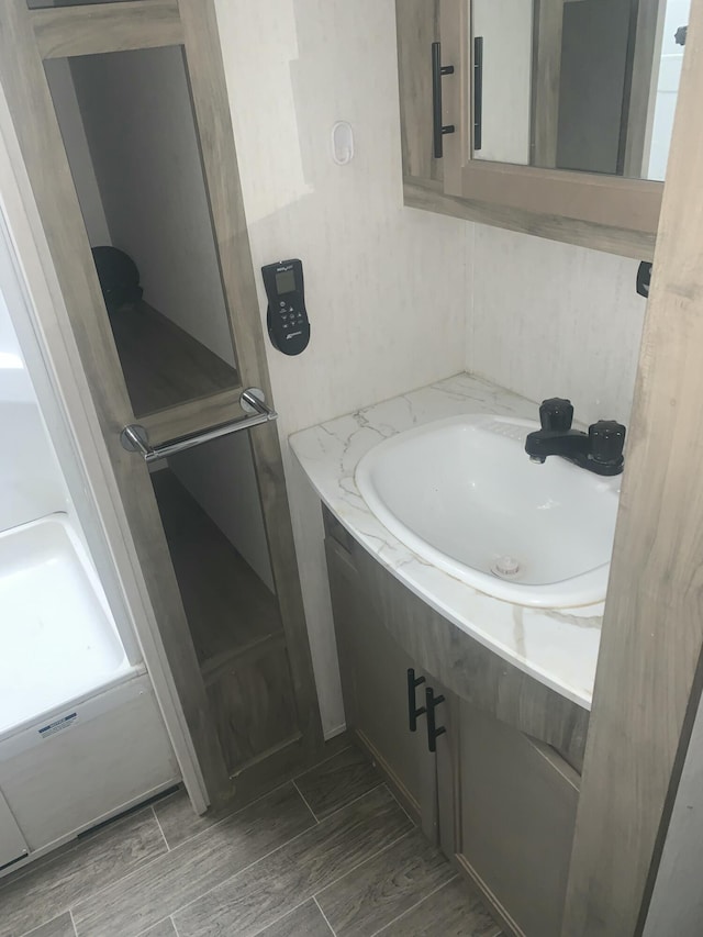 5501 Egner St NE, Cedar Springs, MI 49319 - bathroom with vanity and wood tiled floors