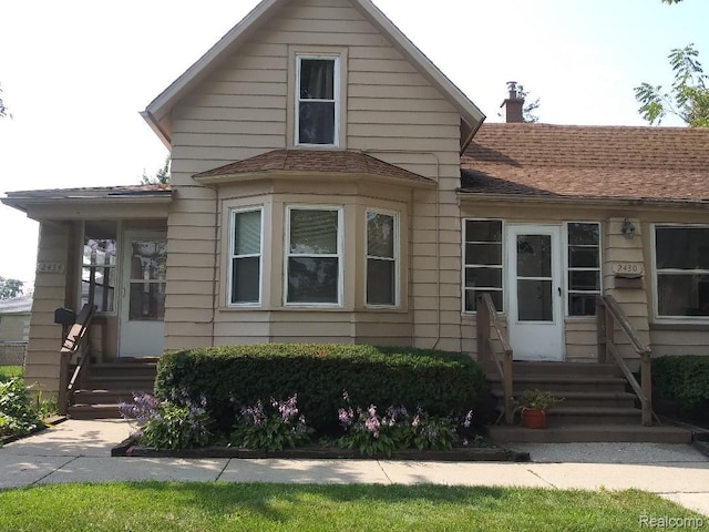 2430 3rd St, Trenton, MI 48183 - bungalow featuring a chimney and a shingled roof