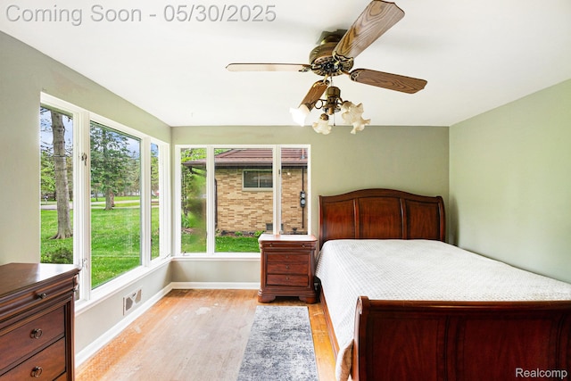 6151 Woodmoor Dr, Burton, MI 48509 - bedroom featuring light wood finished floors, baseboards, and a ceiling fan