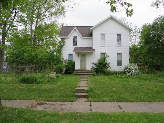 236 S Jeffery Ave, Ithaca, MI 48847 - view of front of home with roof with shingles and a front yard