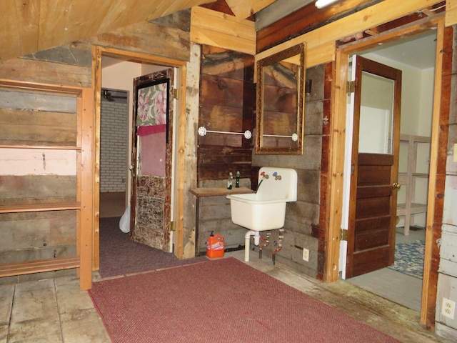 236 S Jeffery Ave, Ithaca, MI 48847 - bathroom with vaulted ceiling and wooden walls