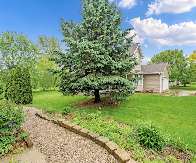 702 Starfield Dr, Pinckney, MI 48169 - view of green lawn with a garage