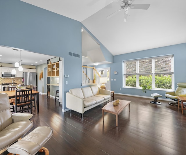 702 Starfield Dr, Pinckney, MI 48169 - living room featuring baseboards, stairs, high vaulted ceiling, ceiling fan, and dark wood-type flooring