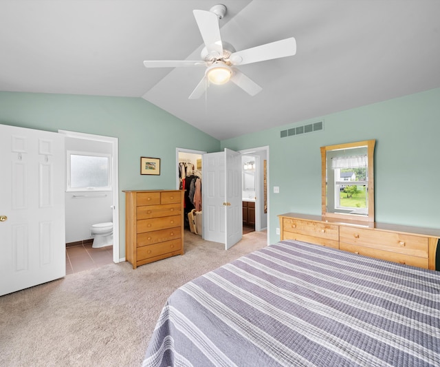 702 Starfield Dr, Pinckney, MI 48169 - bedroom with a walk in closet, light colored carpet, ensuite bathroom, a closet, and lofted ceiling