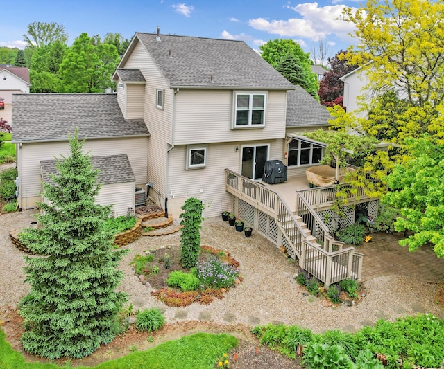 702 Starfield Dr, Pinckney, MI 48169 - back of property featuring a shingled roof, a wooden deck, and stairs