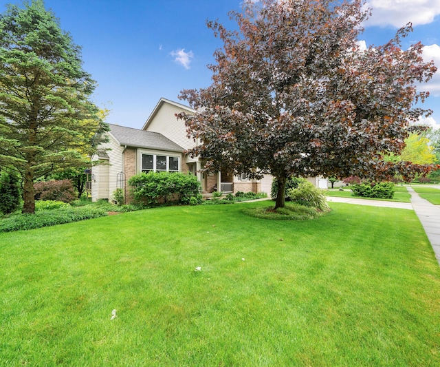 702 Starfield Dr, Pinckney, MI 48169 - obstructed view of property featuring a front lawn and brick siding