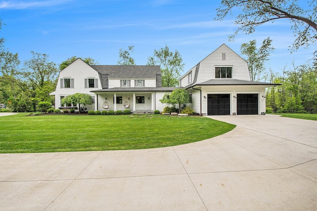 310 Lakeside Dr SE, East Grand Rapids, MI 49506 - dutch colonial featuring a gambrel roof, covered porch, a garage, concrete driveway, and a front yard