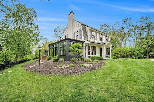 310 Lakeside Dr SE, East Grand Rapids, MI 49506 - view of front of house with a sunroom and a chimney