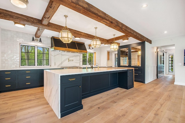 310 Lakeside Dr SE, East Grand Rapids, MI 49506 - kitchen featuring light wood-type flooring, healthy amount of natural light, beamed ceiling, and recessed lighting