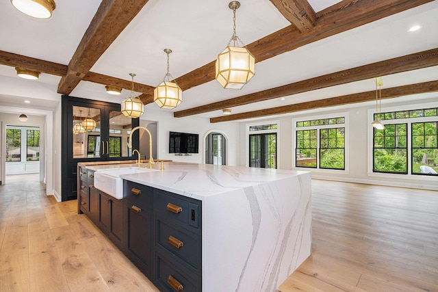 310 Lakeside Dr SE, East Grand Rapids, MI 49506 - kitchen with open floor plan, beam ceiling, a sink, recessed lighting, and light wood-style floors