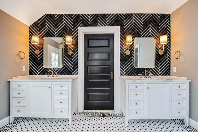 310 Lakeside Dr SE, East Grand Rapids, MI 49506 - full bath with two vanities, tile walls, baseboards, and an accent wall
