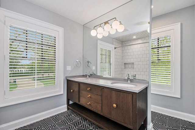 310 Lakeside Dr SE, East Grand Rapids, MI 49506 - bathroom featuring double vanity and baseboards