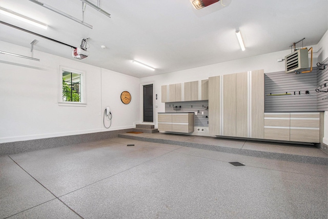 310 Lakeside Dr SE, East Grand Rapids, MI 49506 - garage featuring baseboards, a heating unit, and a garage door opener