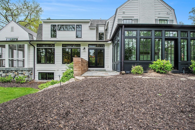 310 Lakeside Dr SE, East Grand Rapids, MI 49506 - view of front of home with a sunroom, a gambrel roof, and french doors