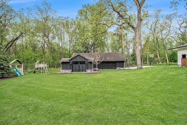 310 Lakeside Dr SE, East Grand Rapids, MI 49506 - view of grassy yard with an outdoor structure, a playground, and a garage