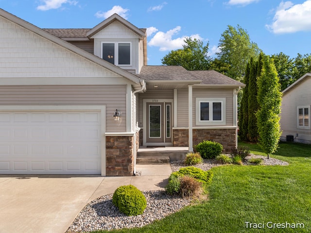 1733 Grevel Ct, Muskegon, MI 49444 - view of front of home with stone siding, a front yard, and a shingled roof