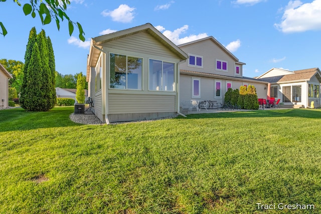 1733 Grevel Ct, Muskegon, MI 49444 - view of front of home featuring a front yard, a patio, and central air condition unit