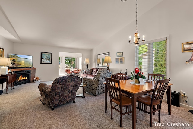 1733 Grevel Ct, Muskegon, MI 49444 - dining area featuring lofted ceiling, carpet floors, a chandelier, a lit fireplace, and baseboards