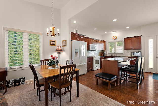1733 Grevel Ct, Muskegon, MI 49444 - dining area with a chandelier, dark wood-style flooring, and recessed lighting