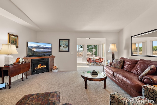 1733 Grevel Ct, Muskegon, MI 49444 - carpeted living room with a tile fireplace, vaulted ceiling, and baseboards