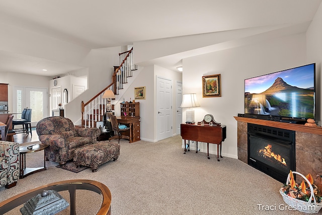 1733 Grevel Ct, Muskegon, MI 49444 - carpeted living room featuring stairway, a tiled fireplace, and baseboards