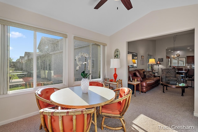 1733 Grevel Ct, Muskegon, MI 49444 - carpeted dining area with lofted ceiling, healthy amount of natural light, a ceiling fan, and baseboards