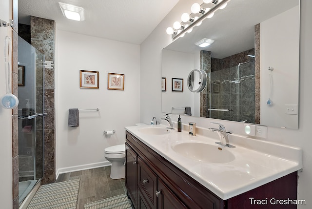 1733 Grevel Ct, Muskegon, MI 49444 - full bath with double vanity, toilet, a stall shower, and baseboards