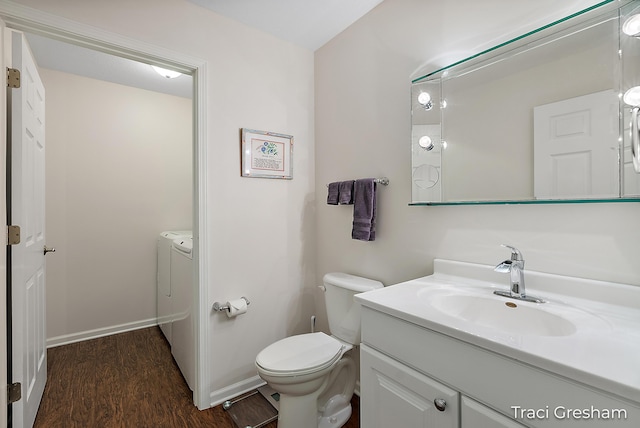 1733 Grevel Ct, Muskegon, MI 49444 - half bath featuring toilet, washer and dryer, vanity, wood finished floors, and baseboards