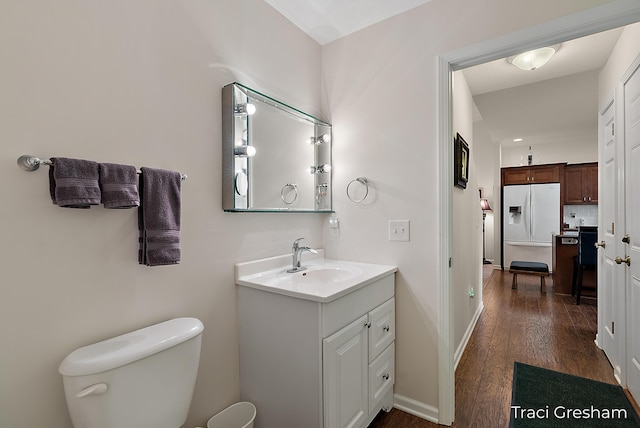 1733 Grevel Ct, Muskegon, MI 49444 - bathroom with vanity, toilet, wood finished floors, and baseboards
