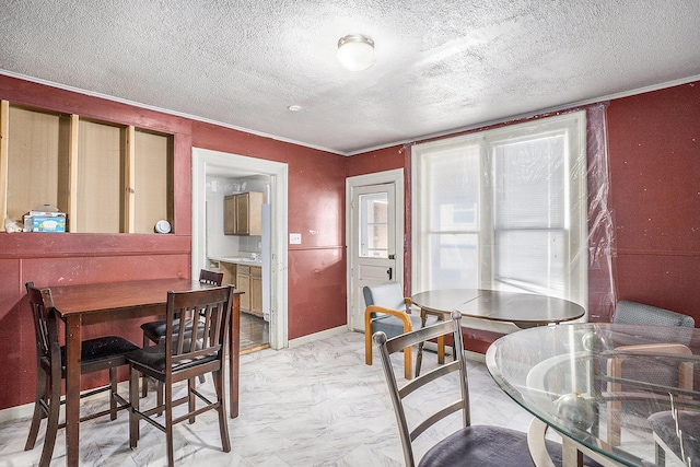706 N Linn St, Bay City, MI 48706 - dining area featuring light marble finish flooring, a textured ceiling, baseboards, and ornamental molding