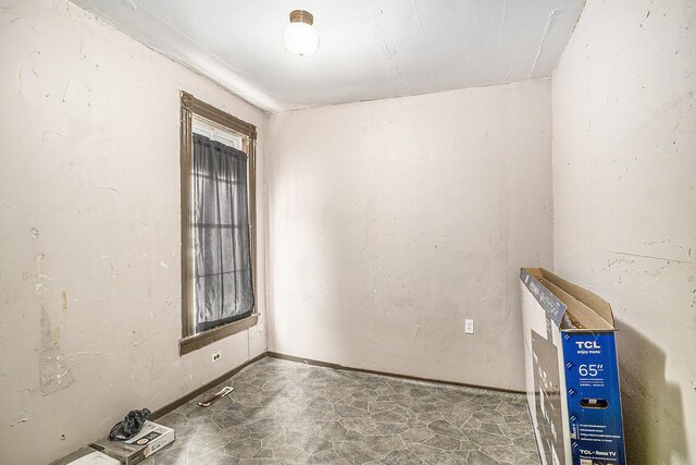 706 N Linn St, Bay City, MI 48706 - spare room featuring baseboards and stone finish flooring