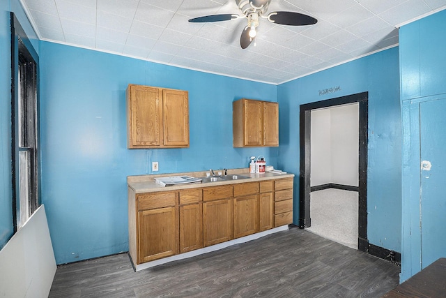 706 N Linn St, Bay City, MI 48706 - kitchen featuring dark wood-style flooring, brown cabinets, a ceiling fan, and a sink