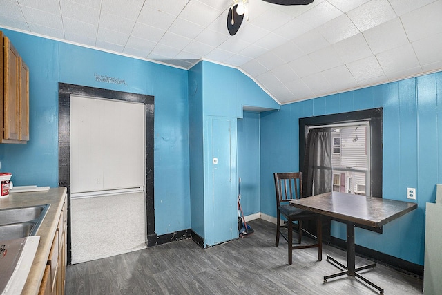 706 N Linn St, Bay City, MI 48706 - kitchen with dark wood-style floors, baseboards, ceiling fan, and lofted ceiling