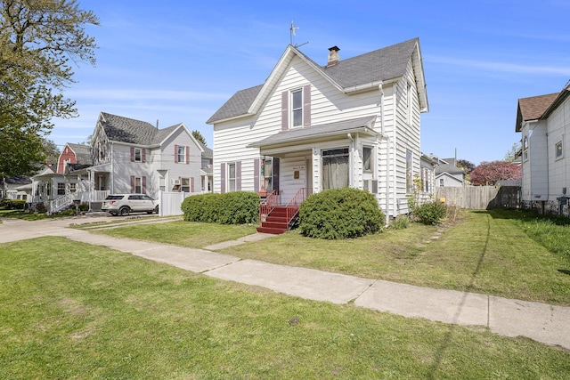 706 N Linn St, Bay City, MI 48706 - view of front facade featuring a residential view, a chimney, and a shingled roof
