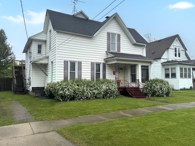 706 N Linn St, Bay City, MI 48706 - view of front of property with stairway, a front lawn, and a shingled roof