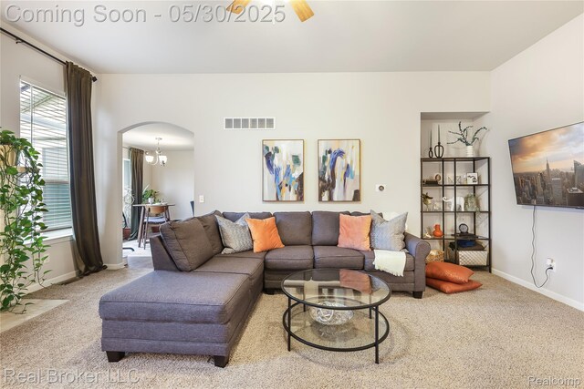 4428 Cross Creek Blvd, Burton, MI 48509 - living area with arched walkways, carpet, and healthy amount of natural light