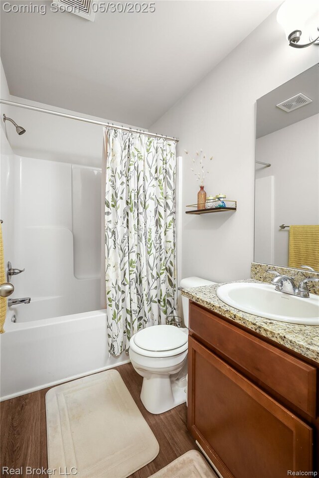 4428 Cross Creek Blvd, Burton, MI 48509 - full bathroom with vanity, shower / tub combo, wood finished floors, and toilet