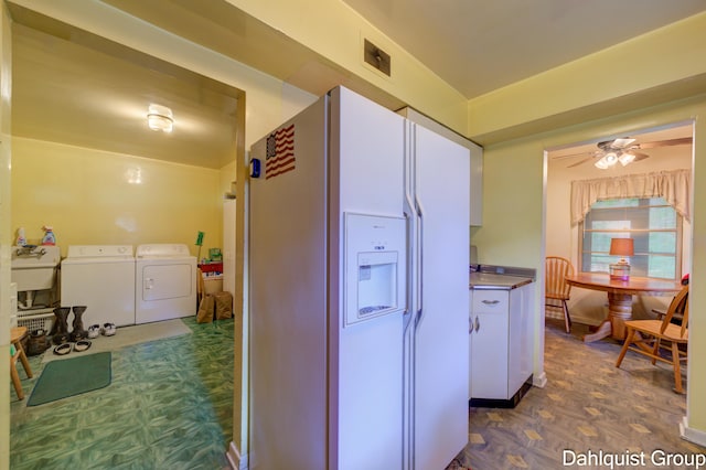 2587 Pennsylvania Ave, Muskegon, MI 49445 - kitchen featuring white fridge with ice dispenser, independent washer and dryer, a ceiling fan, and dark floors