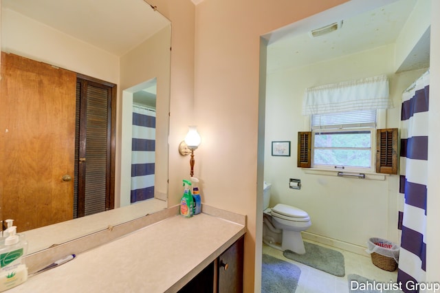 2587 Pennsylvania Ave, Muskegon, MI 49445 - bathroom with toilet, vanity, tile patterned floors, and baseboards