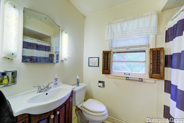 2587 Pennsylvania Ave, Muskegon, MI 49445 - bathroom with vanity, toilet, and a shower with shower curtain