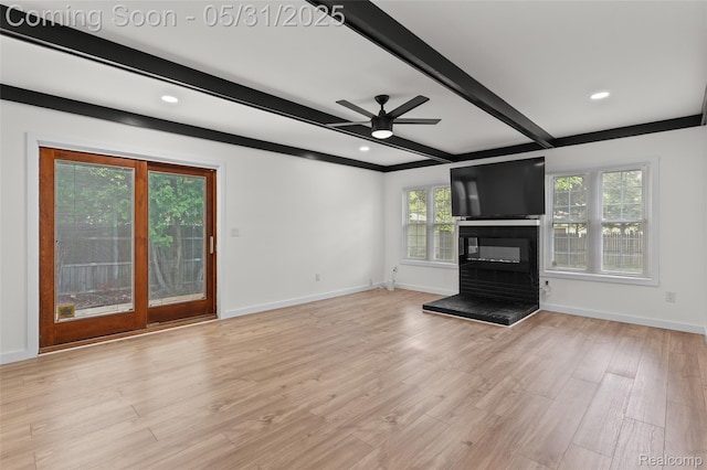 27677 Doreen St, Farmington Hills, MI 48336 - unfurnished living room with a glass covered fireplace, beam ceiling, healthy amount of natural light, a ceiling fan, and baseboards