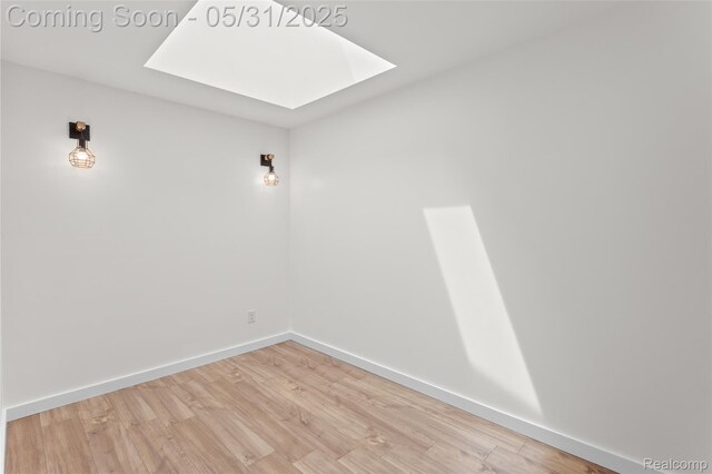 27677 Doreen St, Farmington Hills, MI 48336 - spare room featuring a skylight, wood finished floors, and baseboards