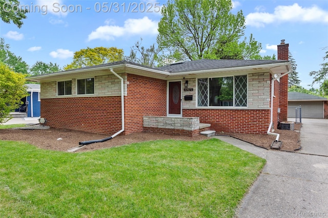 27677 Doreen St, Farmington Hills, MI 48336 - view of front of house featuring a chimney, a front yard, and brick siding