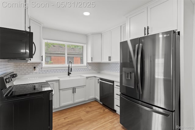 27677 Doreen St, Farmington Hills, MI 48336 - kitchen featuring black appliances, a sink, white cabinetry, tasteful backsplash, and light countertops