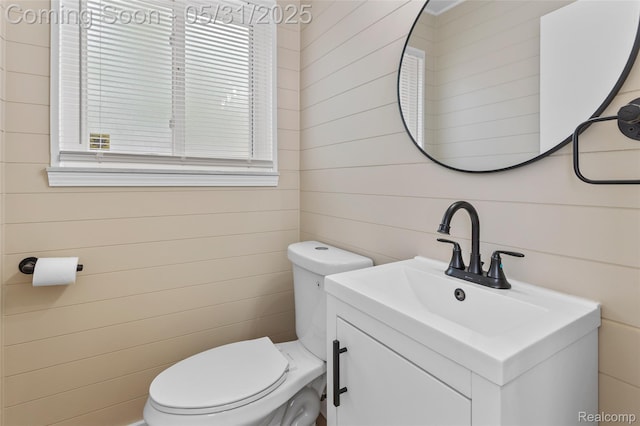 27677 Doreen St, Farmington Hills, MI 48336 - bathroom featuring toilet, vanity, and wooden walls