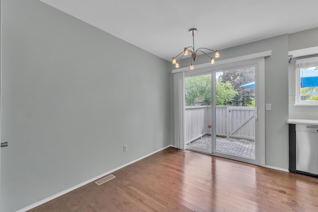 2840 Bombridge Ct, Ann Arbor, MI 48104 - unfurnished dining area with a chandelier, wood finished floors, and baseboards